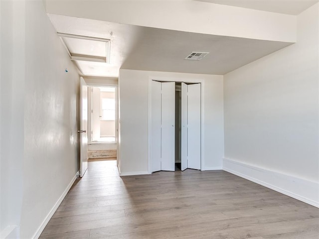 unfurnished bedroom featuring a closet and light hardwood / wood-style flooring