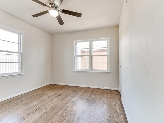 empty room featuring ceiling fan and light hardwood / wood-style flooring