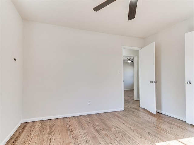 empty room featuring ceiling fan and light hardwood / wood-style floors