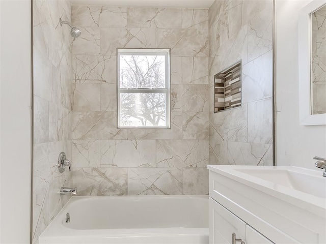 bathroom featuring vanity and tiled shower / bath