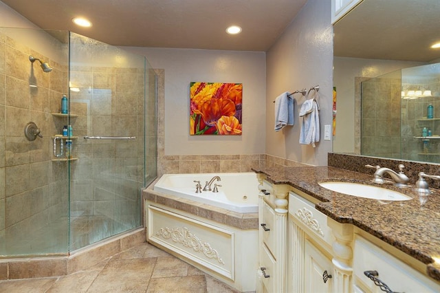 bathroom featuring vanity and independent shower and bath