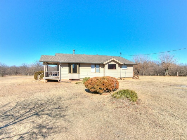 ranch-style home with a porch and a front yard