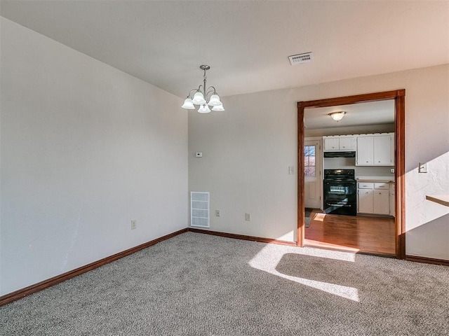 unfurnished room with a chandelier and carpet flooring