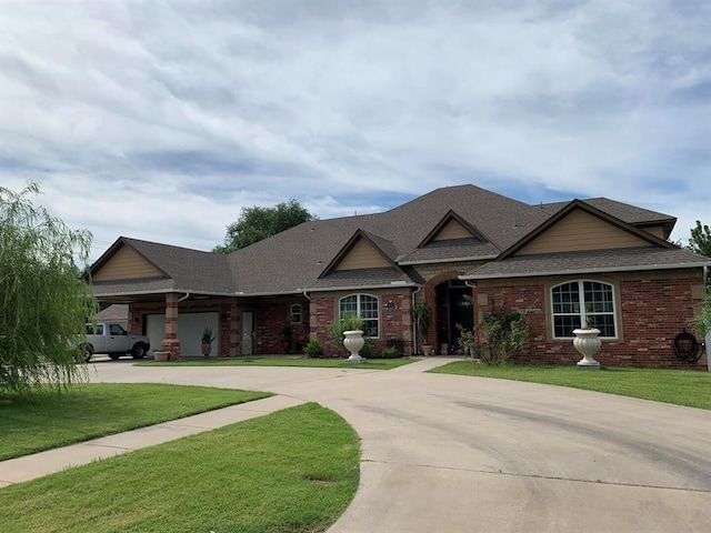 view of front of home with a front yard and a garage