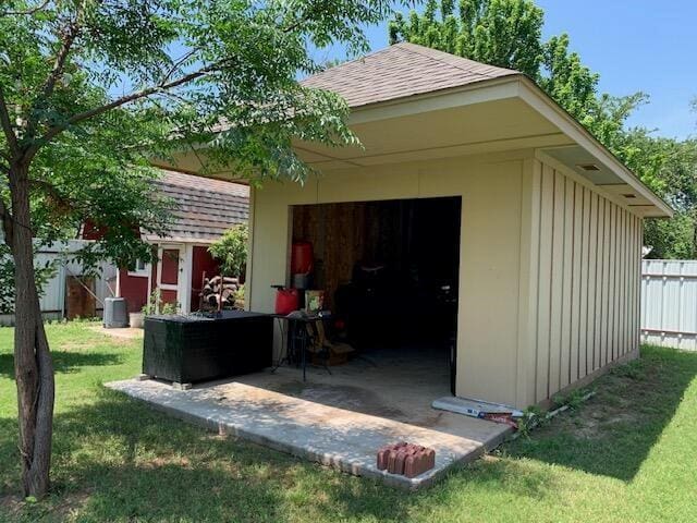 view of outdoor structure featuring a yard and cooling unit