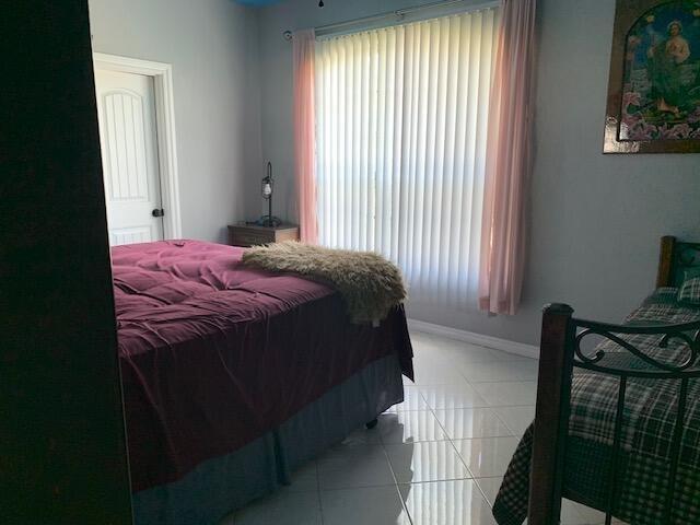 bedroom featuring light tile patterned floors