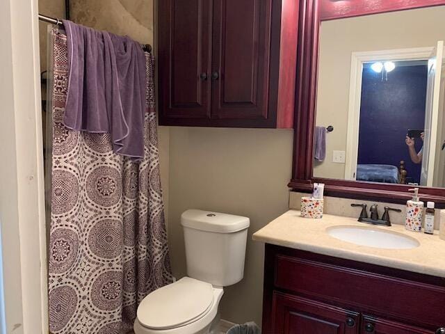 bathroom featuring toilet and vanity