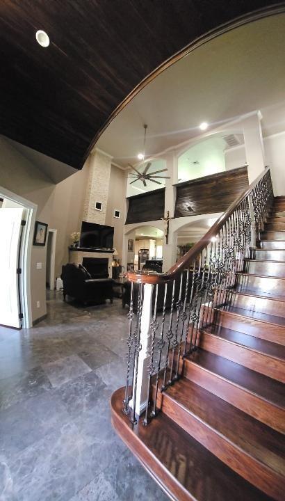 stairs featuring high vaulted ceiling