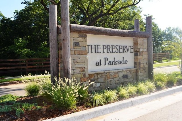 community sign featuring fence