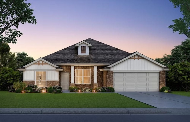 view of front of property featuring a yard and a garage