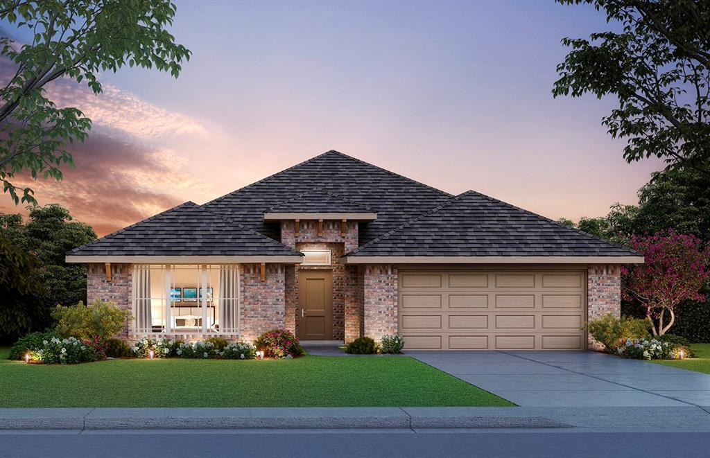 view of front of property featuring a garage and a yard