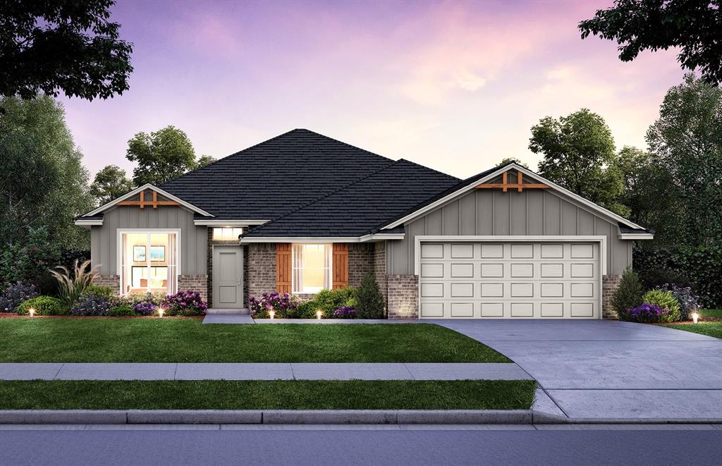 view of front of home featuring a lawn and a garage