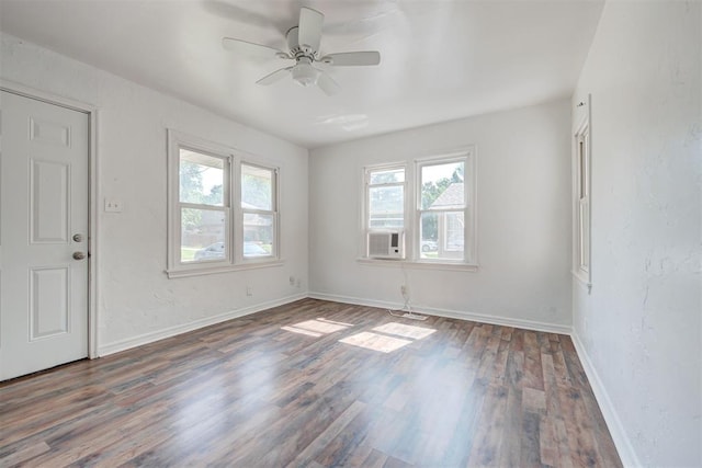 unfurnished room featuring dark wood-type flooring and ceiling fan