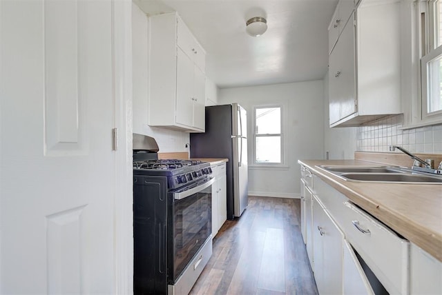 kitchen with white cabinets, appliances with stainless steel finishes, and sink