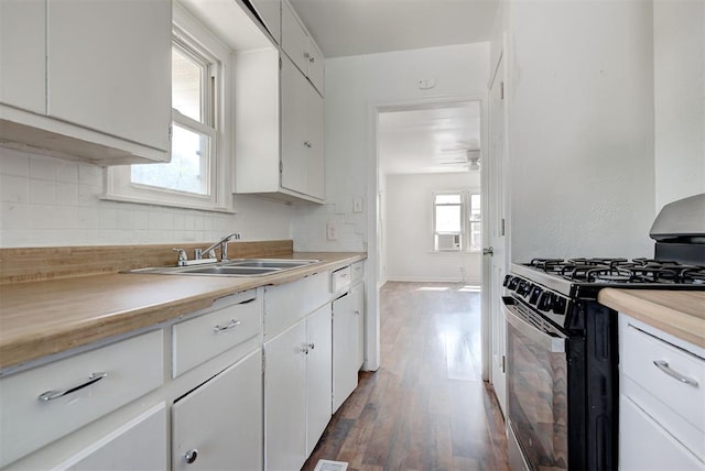 kitchen featuring white cabinets, dark wood-type flooring, sink, ceiling fan, and black range with gas stovetop