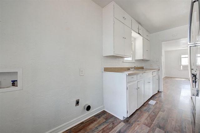 laundry room with washer hookup, cabinets, dark hardwood / wood-style floors, and sink