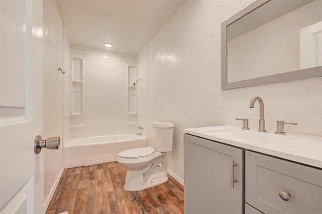 full bathroom with toilet,  shower combination, hardwood / wood-style floors, and vanity