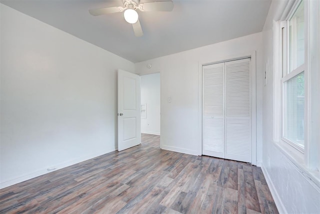 unfurnished bedroom featuring ceiling fan, a closet, and hardwood / wood-style floors