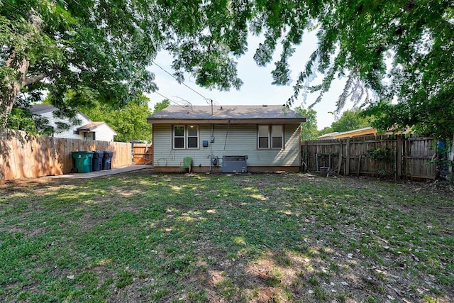 rear view of house with a yard