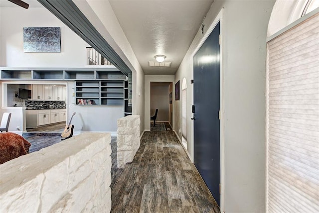 corridor with dark hardwood / wood-style flooring