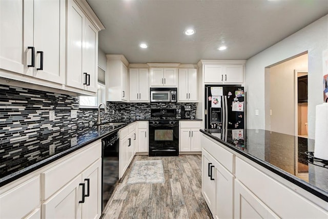 kitchen featuring white cabinetry, sink, and black appliances