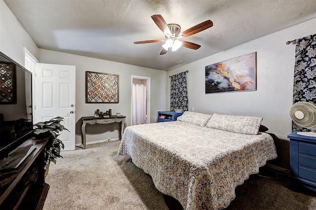 carpeted bedroom featuring a textured ceiling and ceiling fan