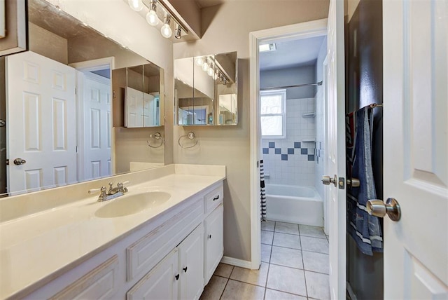 bathroom featuring tiled shower / bath combo, vanity, and tile patterned flooring