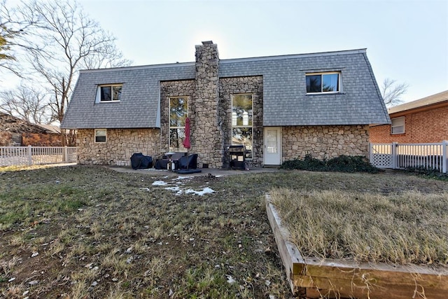 rear view of house with a patio area and a lawn