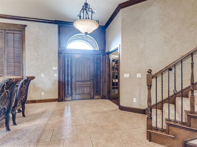 foyer entrance featuring ornamental molding