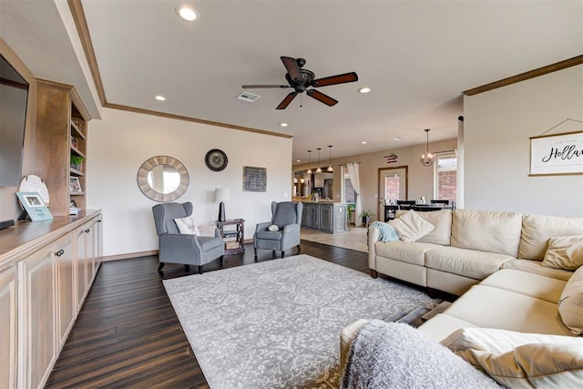 living room with dark wood finished floors, ceiling fan with notable chandelier, recessed lighting, and visible vents