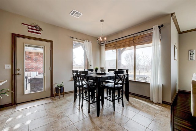 dining space featuring light tile patterned floors, baseboards, an inviting chandelier, and visible vents