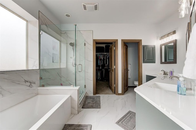 bathroom featuring toilet, marble finish floor, visible vents, a bath, and a stall shower