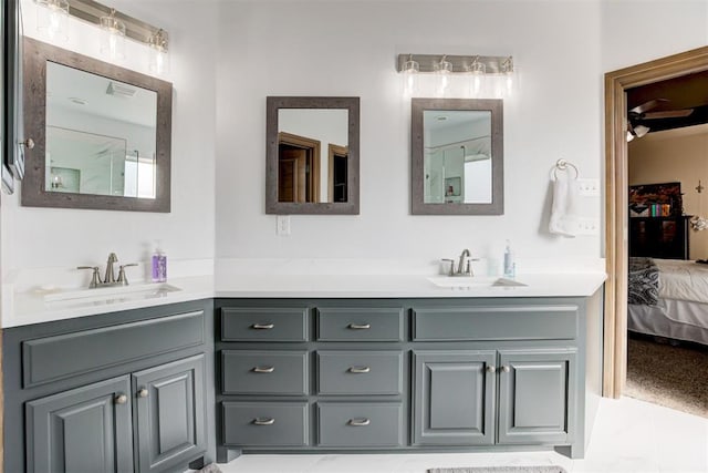 bathroom with a sink, ensuite bath, and double vanity