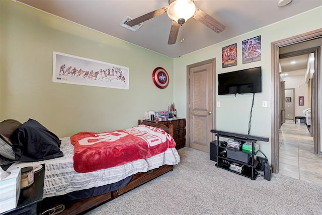 bedroom with carpet flooring, a ceiling fan, and visible vents