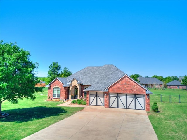 view of front of home featuring brick siding, a garage, fence, and driveway