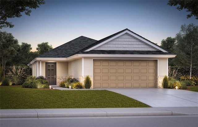 view of front facade with a yard and a garage