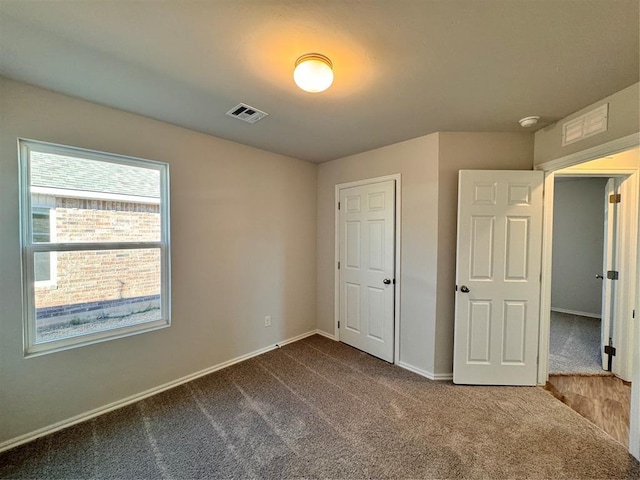 unfurnished bedroom with carpet and a closet