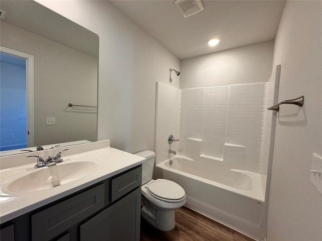 full bathroom featuring shower / bathing tub combination, hardwood / wood-style floors, vanity, and toilet