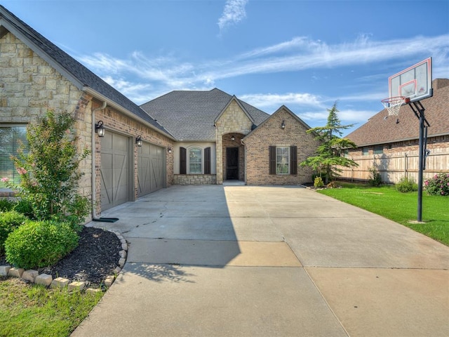 view of front of home with a front yard and a garage