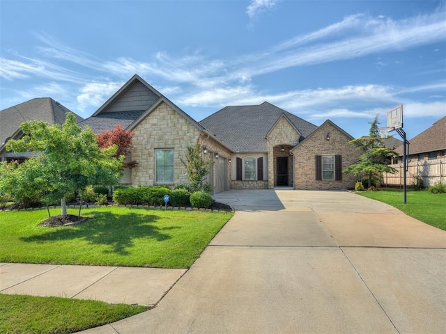 view of front of property with a front yard and a garage