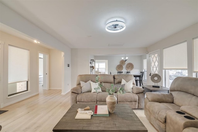 living room featuring light hardwood / wood-style flooring and a chandelier