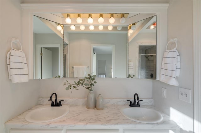 bathroom with a shower with door and vanity