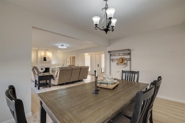 dining space with an inviting chandelier and light hardwood / wood-style floors