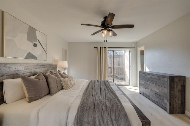 bedroom featuring access to outside, light wood-type flooring, and ceiling fan