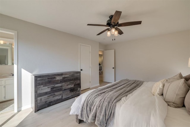 bedroom featuring ensuite bathroom, ceiling fan, and light hardwood / wood-style flooring