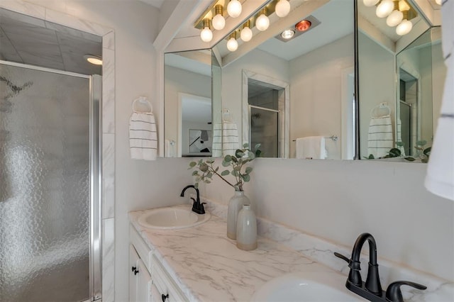 bathroom featuring walk in shower and vanity