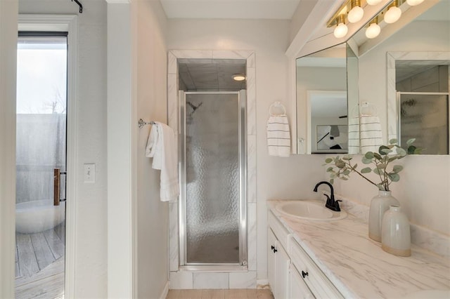 bathroom with an enclosed shower and vanity