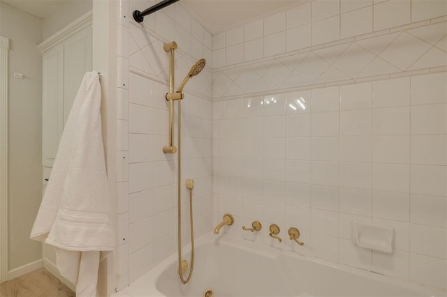 bathroom with wood-type flooring and tiled shower / bath combo