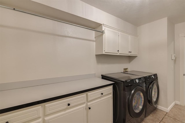 clothes washing area with light tile patterned floors, cabinets, and independent washer and dryer