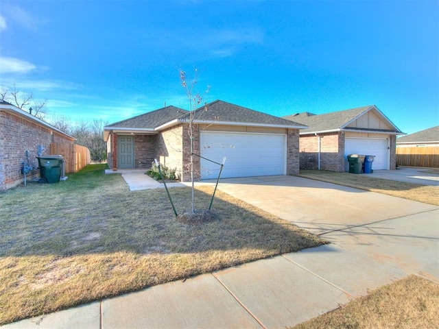 single story home featuring a garage and a front yard